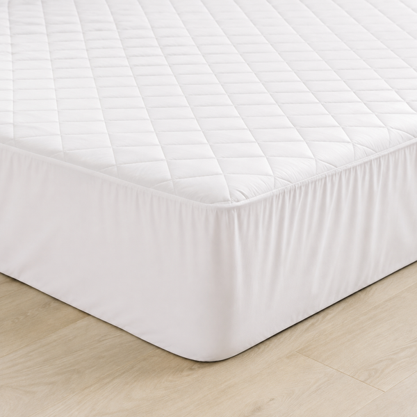 White quilted fitted mattress protector with a deep elasticated skirt